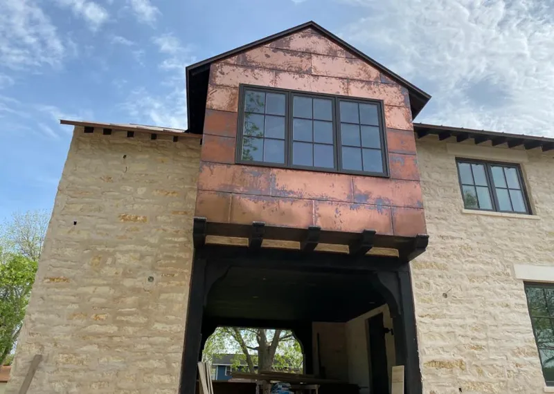 Copper metal panel facade on a stone building for Roof Repair in Waimalu