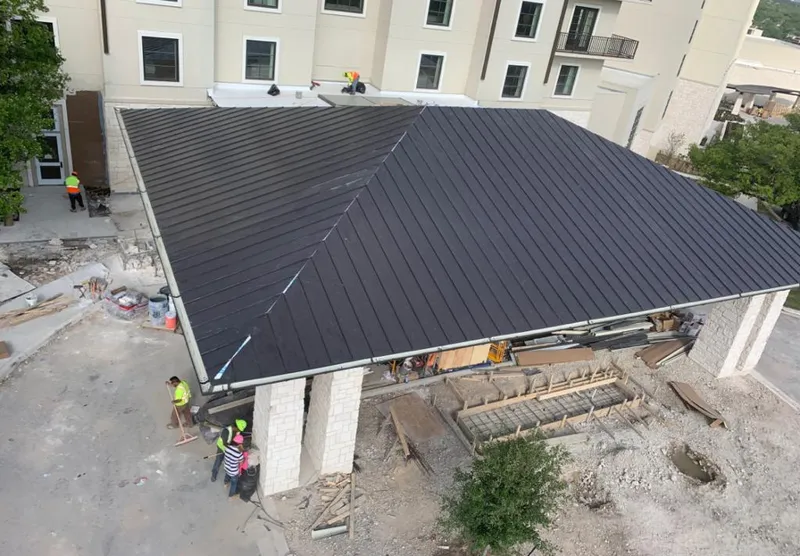 Metal roofing installation team working on a commercial building in Waimalu